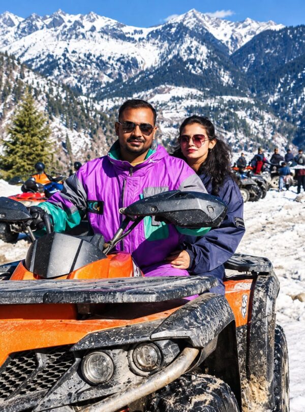 ATV ride in Himachal Pradesh with snow-covered Himalayan mountains